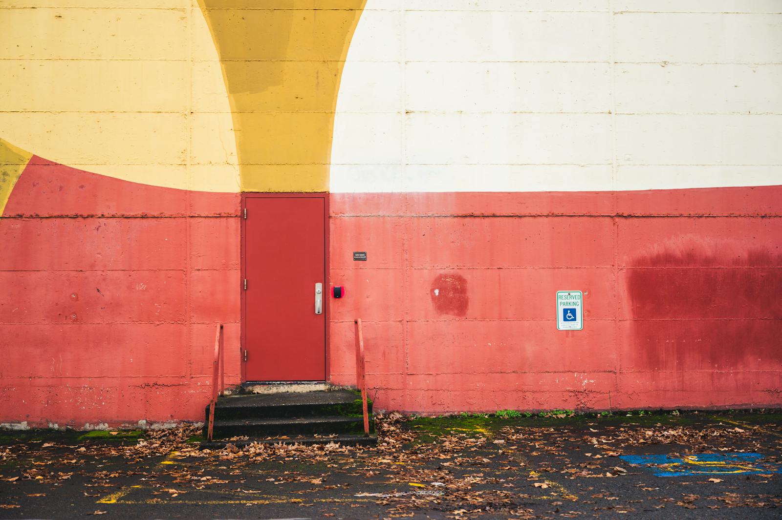 Red yellow graffiti wall with door and stairs